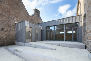 Bâtiment contemporain zinc pierres